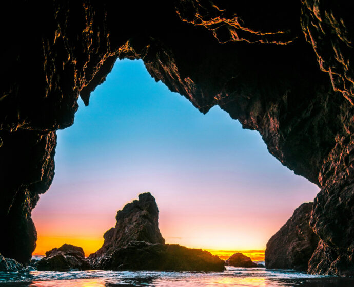 body of water under rock